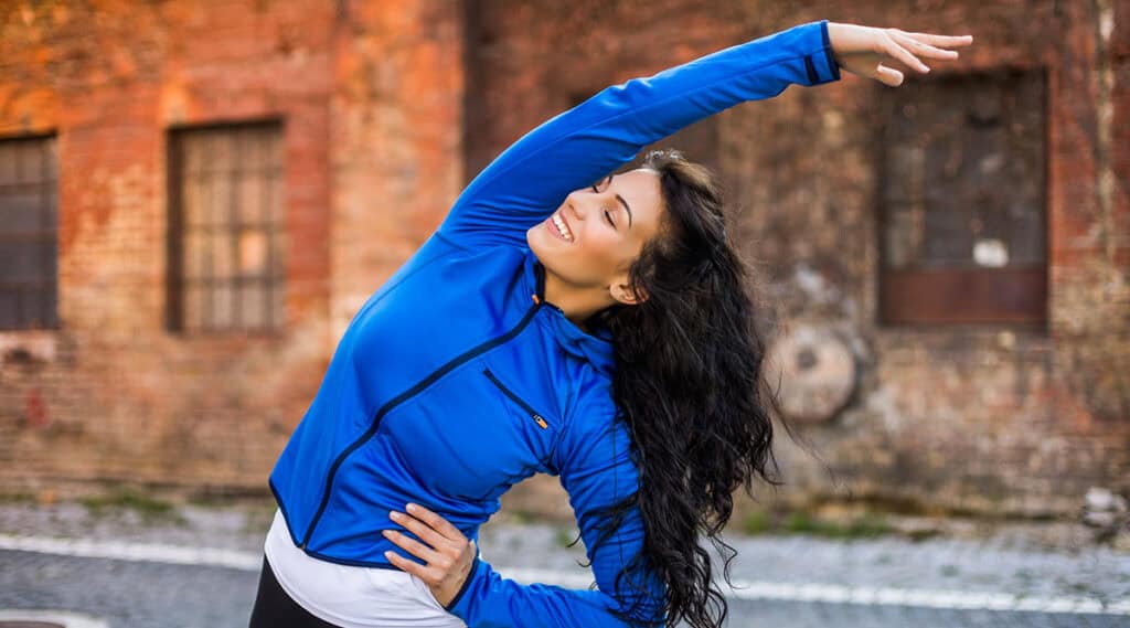 Young woman stretching outdoors during a workout
